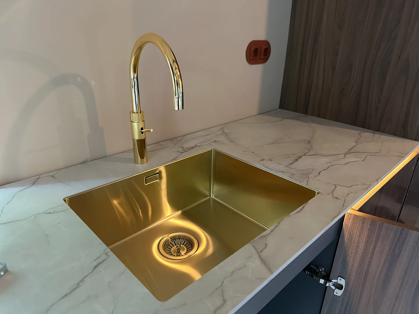 Gouden spoelbak in een marmeren werkblad, een keukentrend in 2026